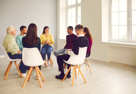group of people having a meeting inside a plain room
